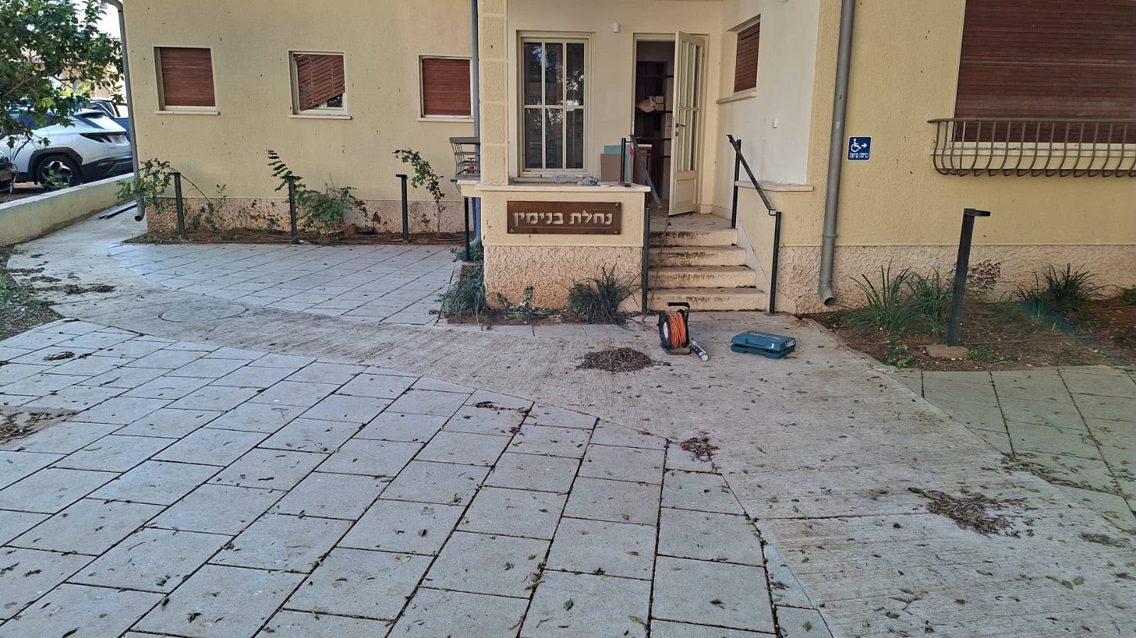 שלט מתכת „נחלת בנימין” בכניסה למבנה